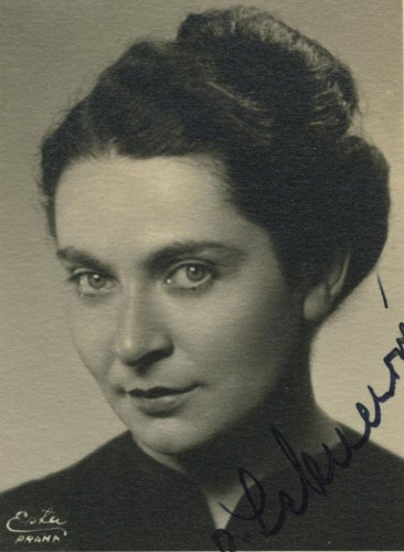 Vintage black and white portrait of an woman with an elegant hairstyle, looking directly at the camera. 