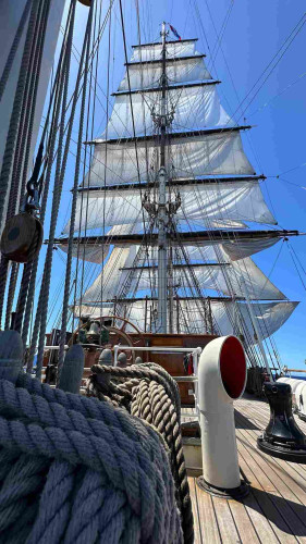 Low angle photo of the six yards on the main mast and some of the square sails on the foremast with stun sails on both port and starboard booms. 