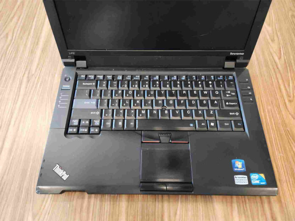 A picture of the ratty looking keyboard and trackpad area of a Levono ThinkPad.