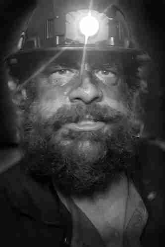 Edvards The Miner:
A bearded man with a filthy, sweaty face, wearing a miners helmet with lamp