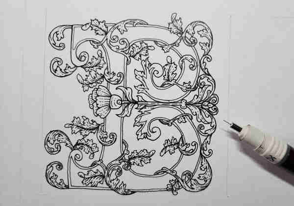 A big ornate letter B decorated with swirling vines and leaves in detailed black ink