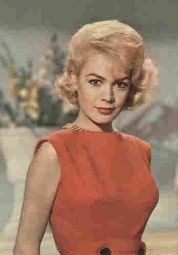 Sandra Dee in a scanned color photo. Wearing a red dress, looking 60s cool.