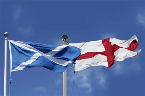 Photograph (colour): Scotish and English flags waving beside each other 
