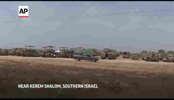 screen capture of video showing 100s of tanks and armored vehicles on the border of Gaza