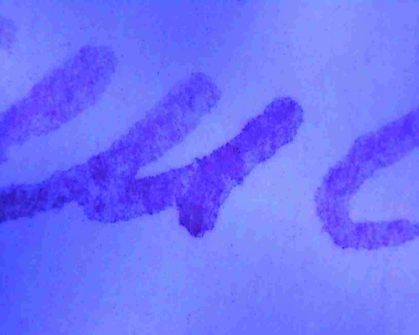 Strokes of a ballpoint pen under purple UV light. 