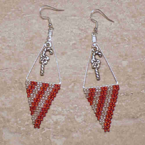 Silver and red Native beaded earrings on a stone background