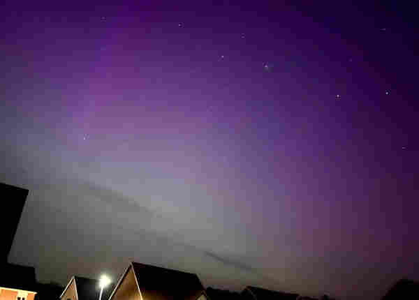 The night sky tinted purple from the Northern Lights