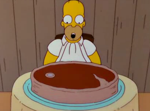 Homer Simpson, mouth agape, stares at a giant steak.