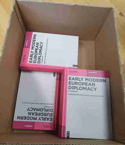 Box with several copies of the Early modern European Diplomacy Handbook. 
