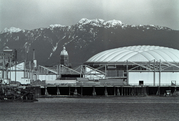 The Sun Tower is clearly visible from the south side of false creek. It appears next to BC Place Stadium. There are snow capped local mountains in the background. 

Kodak TRI-X 
Nikon 85mm f2.0 AIS 
Nikon TC-200
Nikon FE 