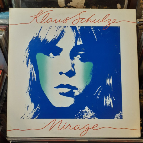 Album cover features a blue, aqua blue, and white image of the artist's face.