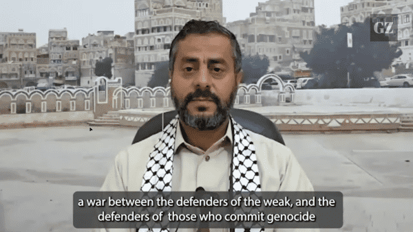A frame from the interview where Ansarallah spokesman describes their struggle against the USA and UK as "a war between the defenders of the weak and the defenders of those who commit genocide".