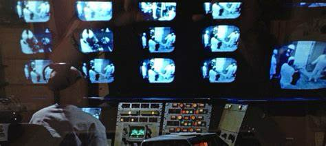 An image from THX 1138 showing a wall of surveillance monitors