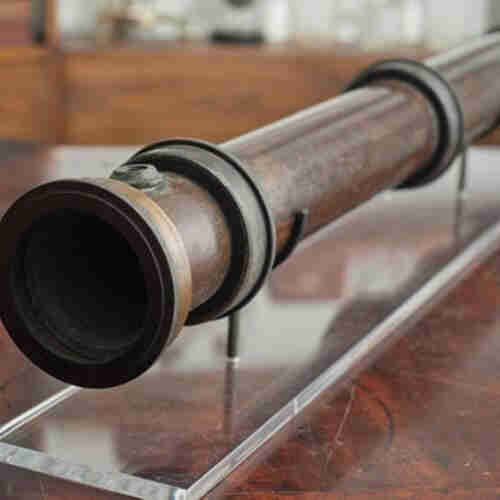 A photograph of the instrument John Tyndall used to measure the absorption & radiation of heat by gases. The instrument looks like a wooden tube

By measuring the thermal energy
emanating from the tube, he could determine how much energy was absorbed by a gas.

This object is currently on display at the Royal Institution in the Faraday Museum, London, England. 
