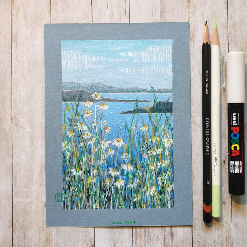 A drawing of a seascape with oxeye daisies in the foreground. The drawing is on blue paper. 