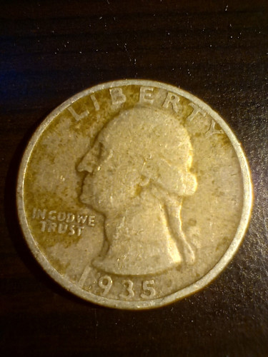 A very worn US quarter dollar dated 1935