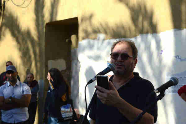 Ofer Cassif speaking to the crowd at a protest.