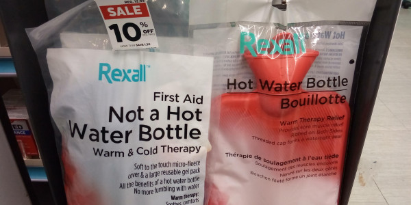 Rexall brand "hot water bottle" and Rexall brand product labeled "Not a hot water bottle". It's unclear what the second bag, which is made of opaque plastic, contains.