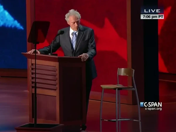 Photo of Clint Eastwood addressing empty chair during speech at 2012 Republican National Convention.