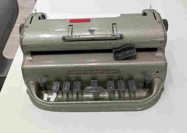 Photo of a Perkins Brailler containing some paper and part of a message is stamped onto it.