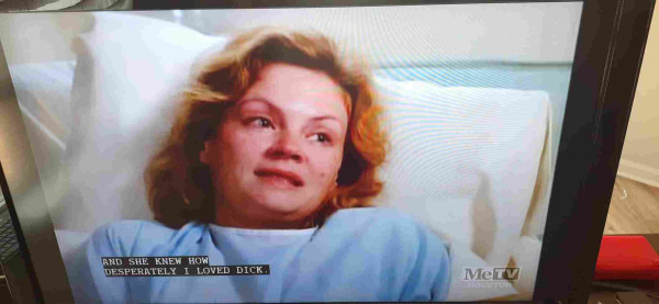 Photo of a TV screen showing an episode of Murder She Wrote. A lady is lying in a hospital bed. Closed Caption reads: "And she knew how desperately I loved Dick."