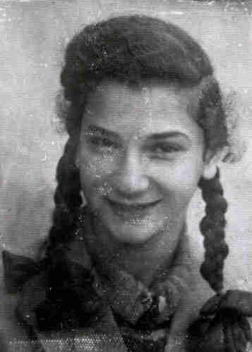 Portrait black and white photograph of a young smiling girl with long braids.