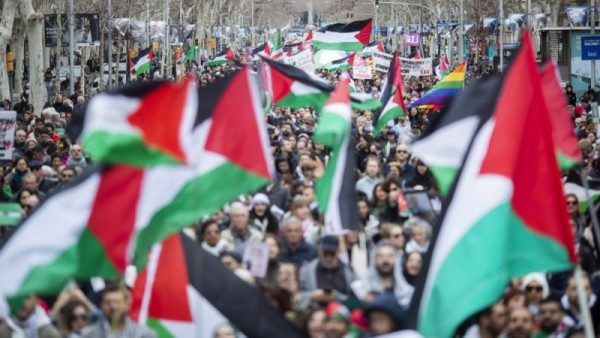 People attend a rally to ask for 'the end of the genocide against Palestine people', and the suspension of weapon trade with Israel, in Barcelona, Spain, 25 February 2024. [EPA-EFE/Marta Perez]