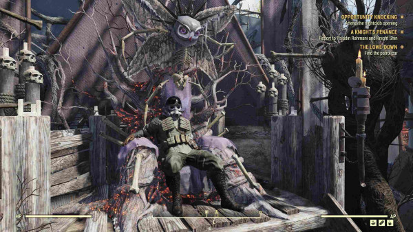 A person in green fatigues and wearing a white combat helmet lounges comfortably on a crude throne. It has a small Mothman motif on top, and is surrounded by skulls and gnarled old tree roots. 