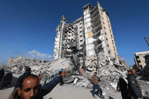 ￼

A Palestinian man points to a damaged building hit in an Israeli strike in Rafah, in the southern Gaza Strip on Sunday (AFP photo)

