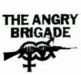 Logo of the Angry Brigade, showing interlinked male/female symbols, superimposed over 2 fists gripping an automatic rifle. By Gordon Carr, The Angry Brigade, Fair use, https://en.wikipedia.org/w/index.php?curid=16548818