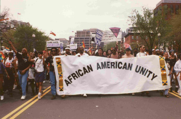 Demonstrators at the 1993 LGBTQ march on Washington, with an "African American Unity" banner. By Elvert Barnes - 54.LGBT.MOW.25April1993, CC BY-SA 2.0, https://commons.wikimedia.org/w/index.php?curid=58385022