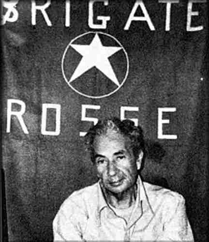 Moro, photographed during his kidnapping by the Red Brigades, in front of a Red Brigades banner. By a member of the Red Brigades - http://www.fabioruini.eu/blog/wp-content/uploads/2008/03/morob.jpg, Public Domain, https://commons.wikimedia.org/w/index.php?curid=56760