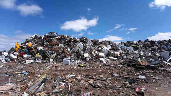 Mounds of unsold and returned products, along with packaging, dumped by Amazon into a landfill.