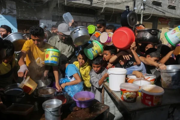 Palestinians struggle for food at a distribution centre in Rafah in southern Gaza [File: Hatem Ali/AP]