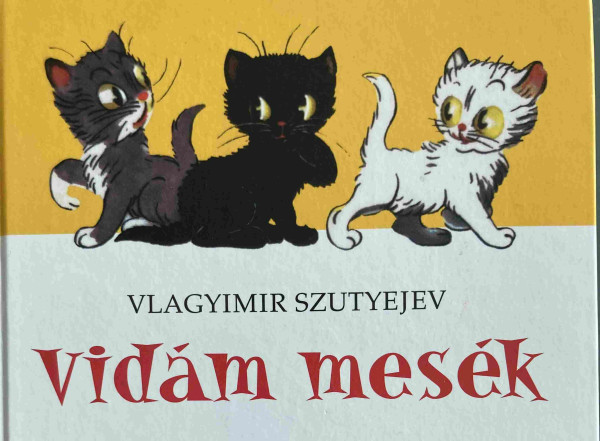 “Vlagyimir Szutyejev: Vidám mesék” cover art top half with 3 kitten, gray, black and white against yellow background 
