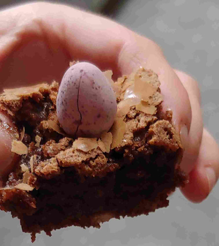 Photo of brownie with a purple mini egg on top, in my hand