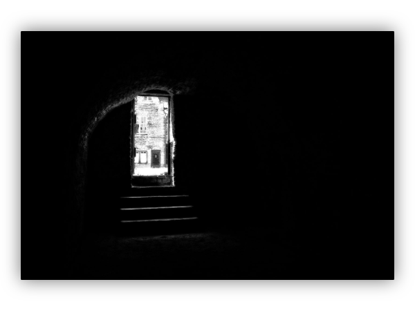 In the dark.  Door and stairs in daylight.