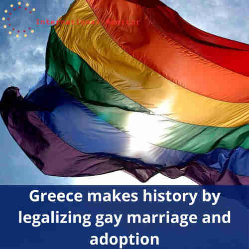 Rainbow flag waving. Behind, blue sky and the sun reflecting through the fabric of the flag. Caption: "Greece makes history by legalizing gay marriage and adoption".