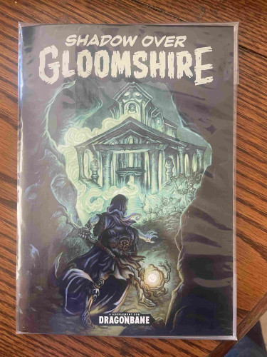 Cover of a role-playing game book titled "Shadow Over Gloomshire," featuring a robed figure with a staff and glowing orb in front of a haunted-looking mansion, with ghostly apparitions surrounding it. Text indicates it's a supplement for Dragonbane.