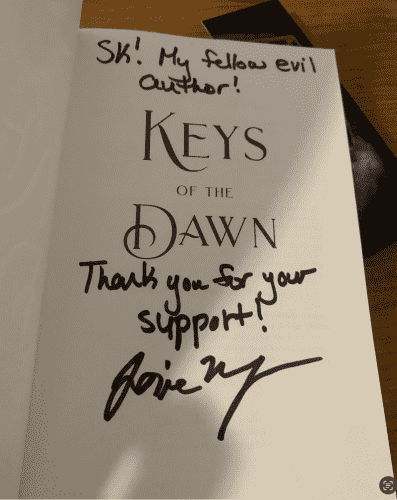 Signed interior of Keys of the Dawn saying "SK! My fellow evil author! Thanks for your support" 
