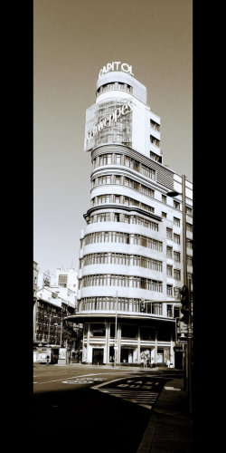 My photo of the Schweppes building in daylight. It's a curved tower like building with windows all around it and at the top it has huge lettering saying Schweppes with a light display behind it. However, as it's daytime the light display is switched off.
I've also played with filters to give a black and white with sepia instead of colours 