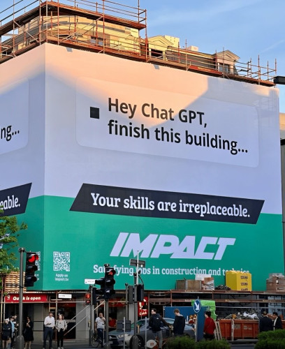 Large ad/mural on the side of a construction site. It reads: hey chat get, finish this building... Your skills are irreplaceable. Impact