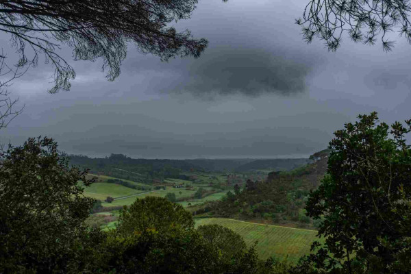 looking out from a bluff over a valley with storm clouds