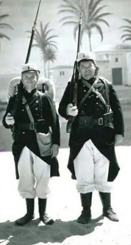 Laurel and Hardy in French Foreign Legion uniform, in a desert studio eet.