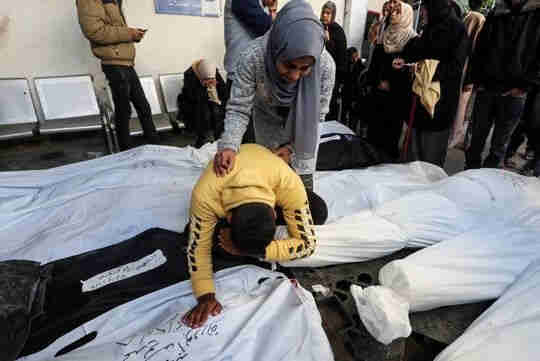 A group of people mourning around several shrouded bodies laid out on the ground.

Bodies of Palestinians, most of whom were killed in Israeli strikes, at a hospital in Rafah earlier this month. 

PHOTO: IBRAHEEM ABU MUSTAFA/REUTERS