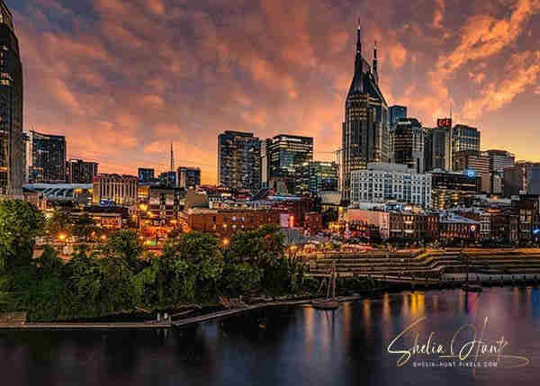Image of Nashville, Tennessee skyline at sunset, overlooking the Cumberland River. Beautiful reflection & stunning sky! From the Fine Art Gallery of Shelia Hunt.