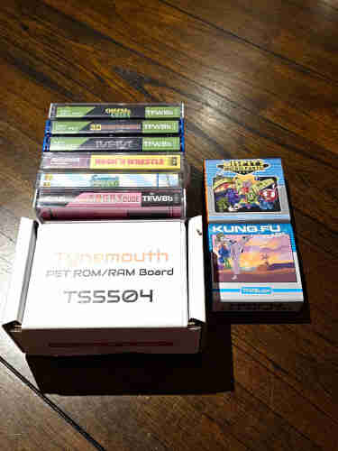 6 cassette tapes and two cartridges for vintage computers as well as a PET ROM/RAM board. 
