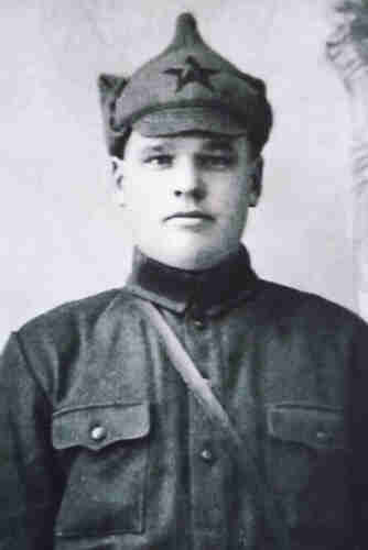 Photo of a Red Army soldier. He is wearing a cap with a five-pointed star and a uniform blouse. 
