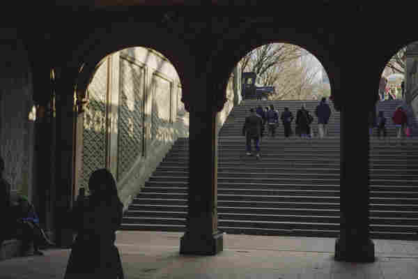 An archway leading out onto a wide set of stairs leading up.