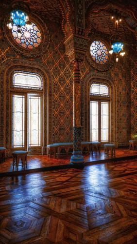 An interior view of a pair of magnificent French windows, each with a stained glass rose window above it. The room is opulent, almost moorish in style, with dark parquet floors and brown and gold wall treatments. 